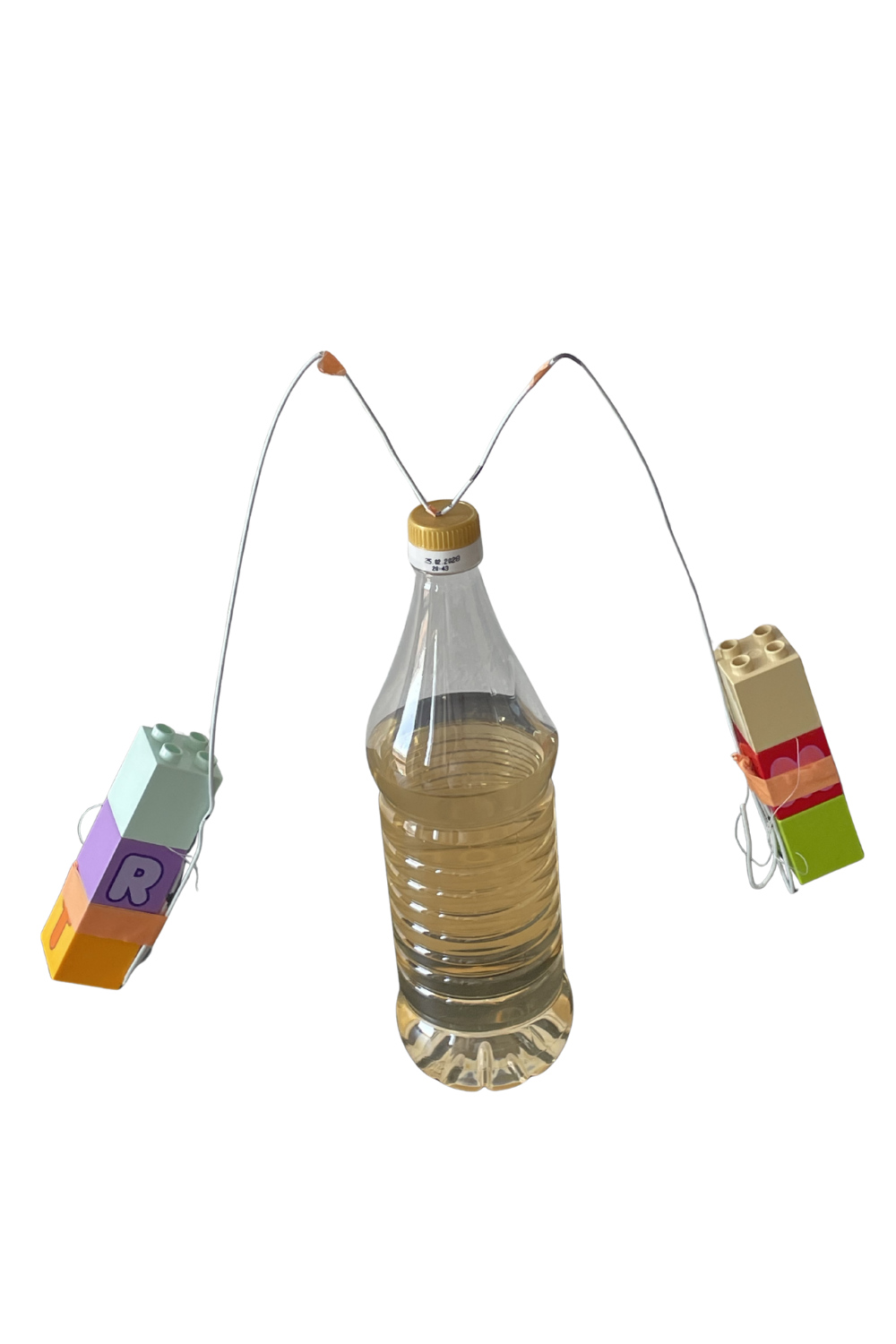 Homemade inertia hat made from a wire coat hanger with Lego weights balanced on a bottle