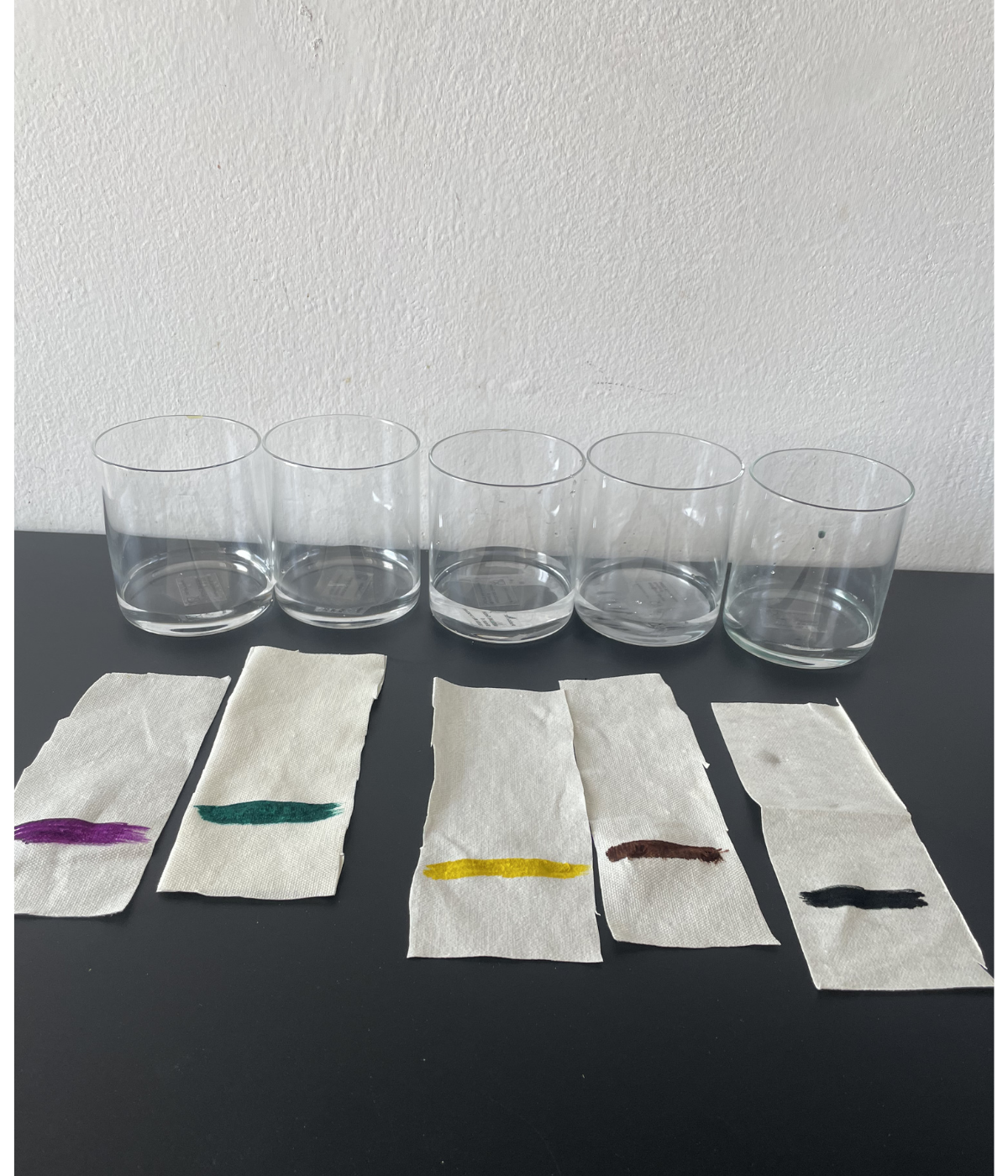 Chromatography experiment setup with washable markers and glasses of water for kids
